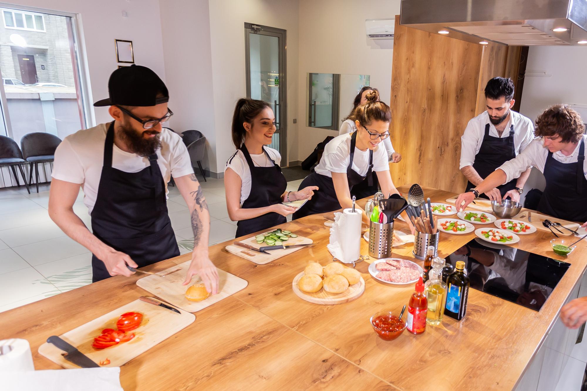 Wide shot of workshop bench with students and chef